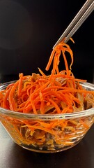 Korean carrot spicy salad in the glass bowl