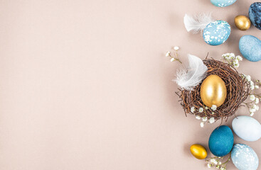 decorations, easter eggs in a nest on a beige background. Happy easter flat lay concept