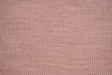 texture of knitted pastel pink sweater, close-up texture of beige pink knitted fabric, macro texture of tan knitted woolen clothes