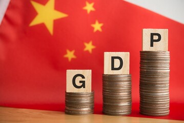 GDP (gross domestic product) character on growth stack coins with Chinese flag background. East...