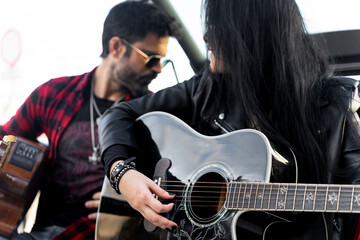 Musicians playing acoustic guitars outdoors