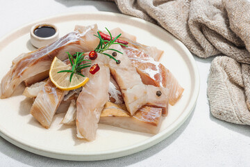 Raw pollock (Pollachius virens) fillet. Fresh fish for healthy food lifestyle. Spices and herbs