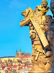 The angels with cross on statue of Madonna and St Bernard on Charles Bridge, Prague, Czechia