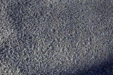 black texture, rough surface, granular pattern, close-up, sparkling effect, abstract background, shimmer, detailed texture, glittering particles, rough material, macro shot, uneven surface, textured 
