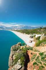 Scenic view of Konyaaltı Beach in Antalya, Turkey, with clear blue waters of Mediterranean Sea and mountains in background. Welcome to Antalya concept image