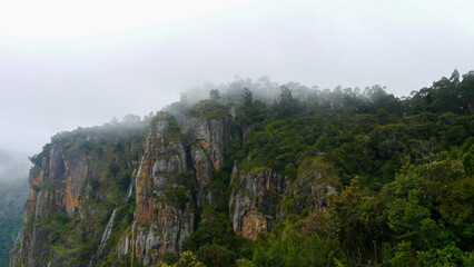 Cloud covered pillar rock mountain formation of palani hills range at Kodaikanal hill station in monsoon season, Tamilnadu, south India. High quality photo