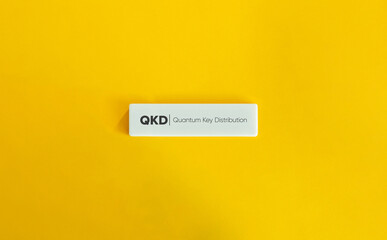 Quantum Key Distribution (QKD). Text on Block Letter Tile on Yellow Background. Minimal Aesthetic.