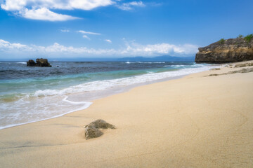 Imagine a serene beach with golden sand, gentle waves, and a clear blue sky, creating an ideal atmosphere for relaxation and escape from daily stress, Nusa Lembongan, Bali, Indonesia