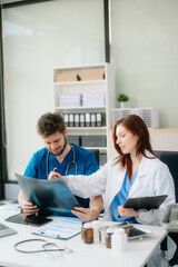 Doctors analyzing results or diagnosis of patient in clinic. Teamwork, medical and healthcare workers