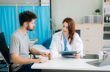 Fototapeta premium Portrait of female doctor explaining diagnosis to her patient. Doctor Meeting With Patient In Exam Room