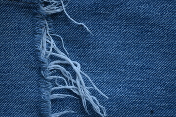 torn light grey denim surface, denim fringe , hole macro texture of blue denim, torn blue denim...