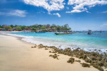 Imagine a serene beach view showcasing stunning blue waters, boats gently anchored in the tranquil bay, and a soft sandy shoreline, ideal for vacation inspiration, Nusa Lembongan, Bali, Indonesia