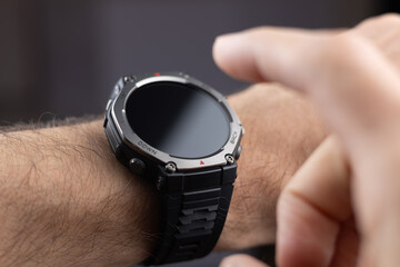 Young business man is late on time, in a hurry she checks the deadline on her smart watch.