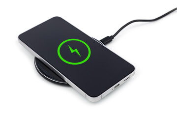 Mobile smartphone on wireless charging device on white background.