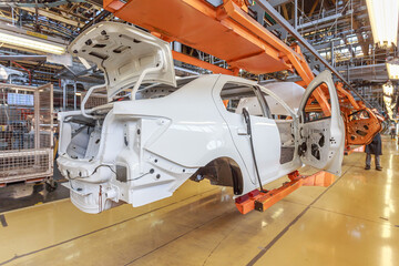 Close view of a car body on an assembly line.