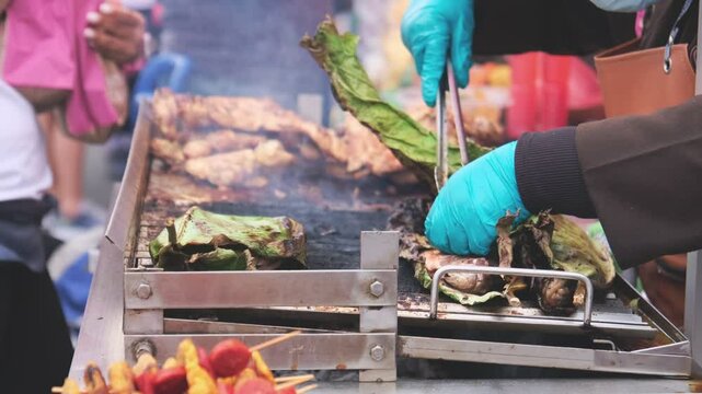 Fish wrapped in banana leaf, grilled chicken, typical street food from the Peruvian jungle