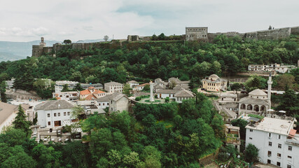 Fototapeta premium Aerial drone view of old quarters of Gjirokaster, Albania. Traditional houses in the old city of Gjirokaster. UNESCO World Heritage Site.
