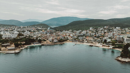 Fototapeta premium Aerial view of tropical beach in Ksamil Islands with turquoise water, Albania. Exotic paradise coastline. Panorama Balkan coast on Ionian sea. 