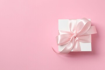 Beautiful gift box on pink background