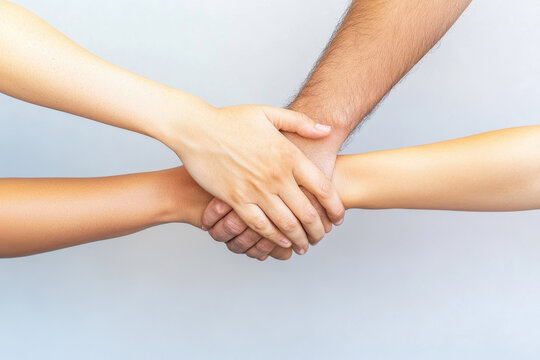 Diverse group of hands united in a symbol of teamwork and unity