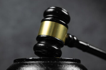 Black judges gavel on the table on a dark background