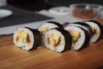 Homemade sushi roll on wood board. Japanese food.