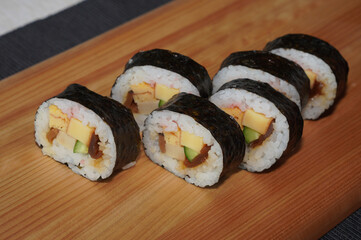 Homemade sushi roll on wood board. Japanese food.