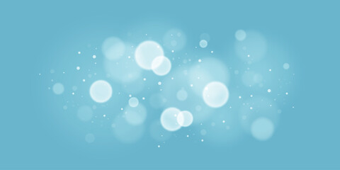 Obraz premium Soft focus light bokeh lights on blue background. Glittering sparkles and shining circles for festive themes. Winter bokeh lights