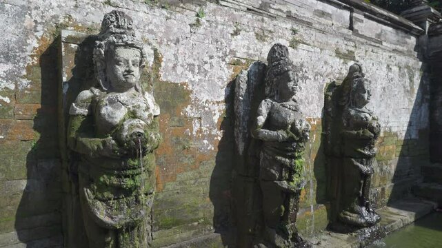 Ritual purifying bath at Goa Gajah Temple in Bali, Indonesia