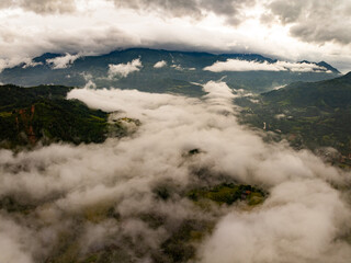Drone aerial view of landscape fog over mountains in sunrise sky,High angle view over countryside at northern Vietnam,Wide angle view