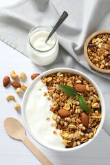 Delicious granola with yogurt on a light background