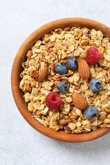 Delicious granola with berries on a light background