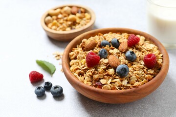 Delicious granola with berries on a light background