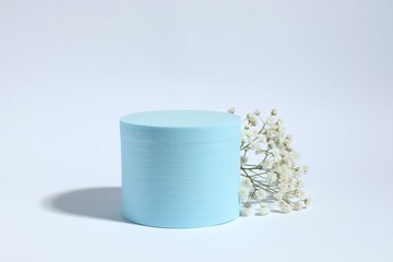 Podium and white gypsophila flowers on white background