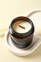 Handmade scented candle in a glass. Soy wax candle with a wooden wick