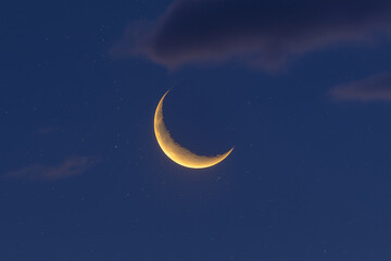 Fototapeta premium Crescent moon glowing in a serene night sky with twinkling stars