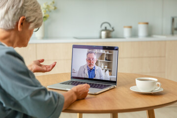 Senior man doctor expert examining older senior woman online. Old woman lady patient and doctor...