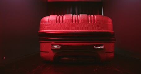 Airport Security Checkpoint: Close Up of Suitcase Moving on Conveyor Belt Inside Advanced Metal Detector X-ray Scanner. Red Light Alert About Detected Suspicious Item on Baggage Screening Procedure.