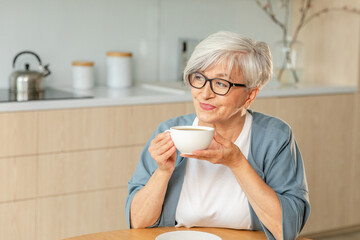 Good morning. Comfort relaxed senior old elderly woman grandmother drinking hot beverage tea coffee...