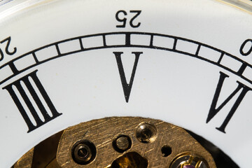 Macro Shot of a Vintage Clock Face with Roman Numerals. 2x close-up with Roman number 5.