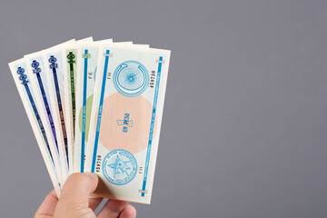 Cuban money in the hand on a gray background