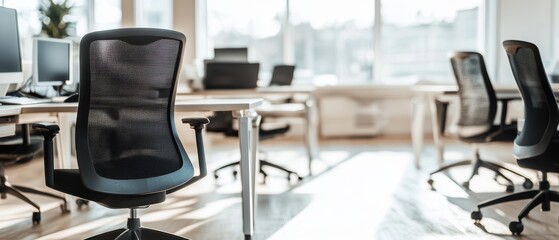 Office environment featuring empty ergonomic chairs and modern workstations, reflecting business productivity, collaboration, and a professional atmosphere.