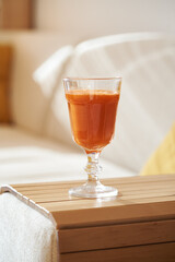 Fresh carrot juice in a glass cup