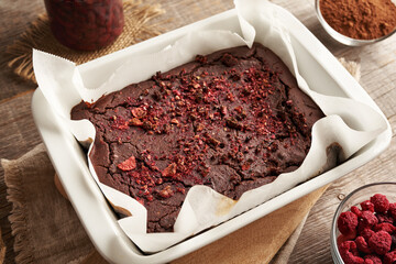 Homemade gluten-free brownies made with red kidney beans, oat flakes, chocolate and freeze-dried berries