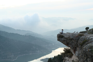 Yogi doing yoga in a cliff in nature