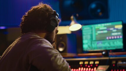 Talented guitarist doing live performance in professional studio, recording new tracks on mixing...
