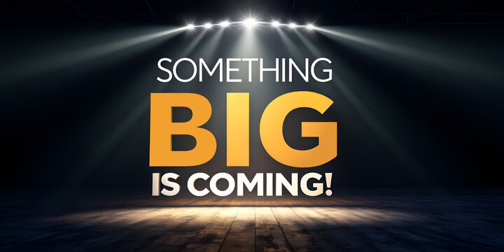 a dark stage with dramatic lighting pointing towards the center. The text "SOMETHING BIG IS COMING!" is prominently displayed in bold, yellow and white letters.