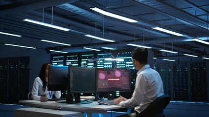 Team of programmers in server hub try to protect hardware from hacker attack stealing sensitive...