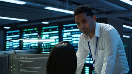Team of admins in data center ensuring system can handle networking tasks. Teamworking colleagues...