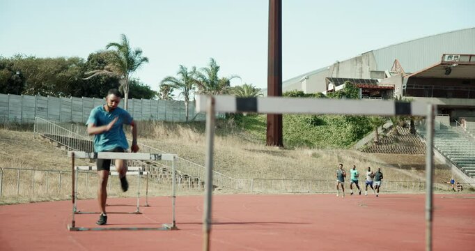 Athlete, man and jump for hurdle outdoor of fitness competition, run exercise and sports performance. Male runner, field and obstacle race with cardio training, olympics challenge and endurance goals